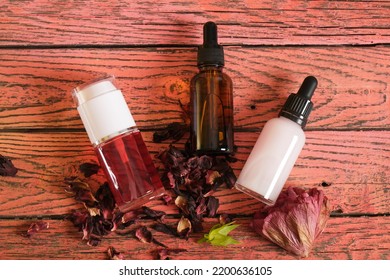 Three Mock Bottles With Natural Cosmetic With Hibiscus Extract On Wooden Background, Spray And Dropper Botlles With Tonic,serum And Oil, Diy Cosmetic Concept