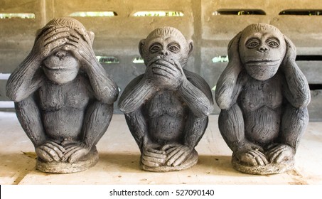 Three monkey,close up of hand small statues with the concept of see no evil, hear no evil and speak no evil.