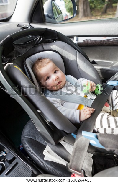 Three month\
infant lying in child safety seat on front passenger\'s seat, the\
chair is in right direction and\
placement