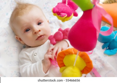 Three Months Old Baby Girl Playing With Toys