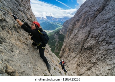 Three Mountain Climbers On A Difficult Via Ferrata In The Dolomites In Alta Badia In The South Tyrol In Italy