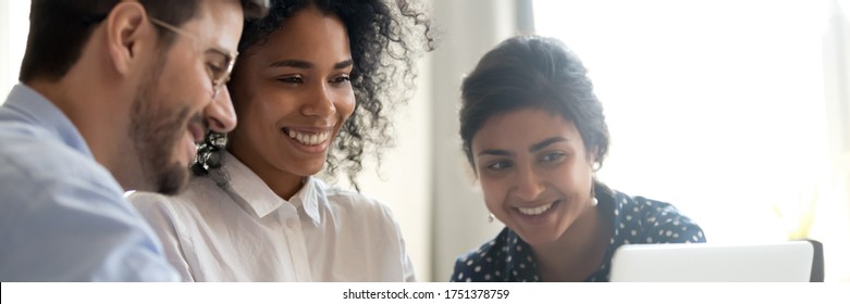 Three Multi Ethnic Colleagues Involved In Learning New Corporate Business Application Seated Together In Coworking Desk, Teamwork Mentoring Concept. Horizontal Photo Banner For Website Header Design