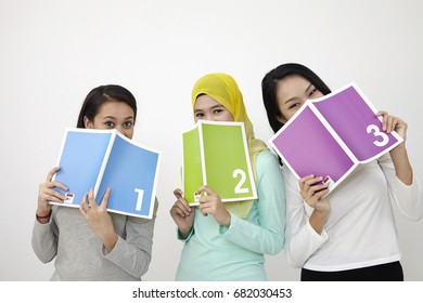 three multi racial malaysian holding book printed 123