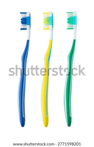 Three multicolored toothbrushes standing vertically for teeth cleaning
