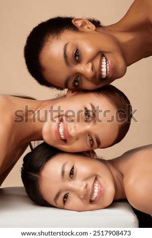 Three Multicultural Ladies Posing Smiling To Camera Over Gray Background. Multiethnic Female Beauty Portrait, Vertical