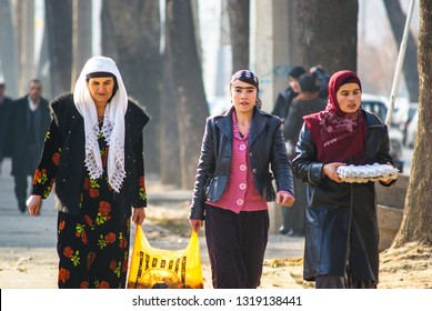 Three Muslim Women Walking Down The Street And Carry Food. Tajikistan. Dushanbe. 27.12.2010