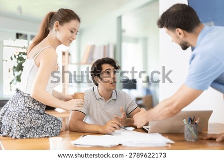 Three office employees read and process documents. Familiarization with contract, business correspondence, letter of claim, employment contract