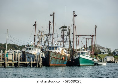 Three Old Fishing Boats In A Harbor, New England, USA