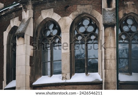 Three old pointed gothic windows with stained glass on facade of the building. Baroque and Gothic architecture. Church of St. Olga and Elizabeth. Lviv, Ukraine. Stock photo © 