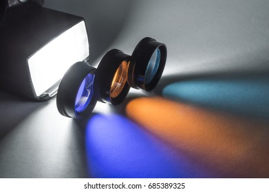 Three optical filters illuminated from the side with a flash, also caught in the frame