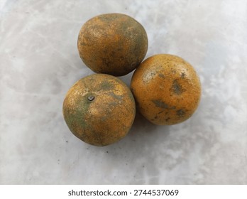 Three oranges on a white table