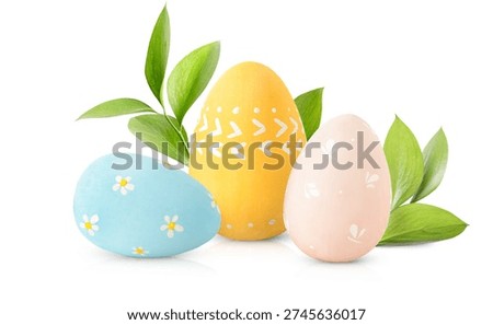 three painted Easter eggs and green twigs on a white isolated background