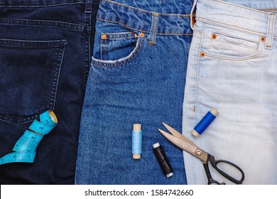 Three Pair Of Jeans With Scissors, Threads And Tailor Meter. Upcycle Concept.