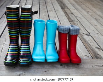 Three Pairs Of A Colorful Rain Boots. Family Concept