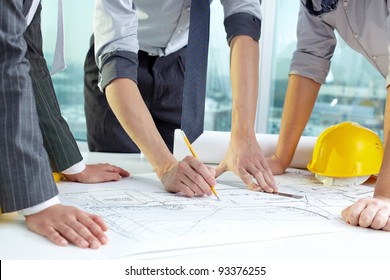 Three pairs of hands sketching a housing project - Powered by Shutterstock