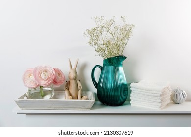 Three Pale Pink Ranunculus In A Transparent Round Vase And Candles On The White Windowsill. Rolled Hand And Face Towel Copy Space. Place For Text