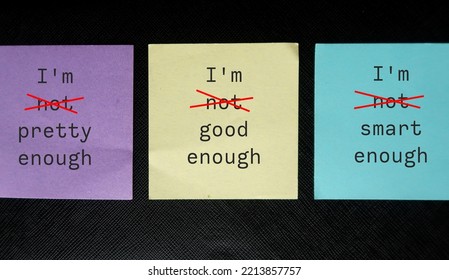 Three paper notes with handwritten text I AM NOT GOOD ENOUGH, NOT SMART ENOUGH, NOT PRETTY ENOUGH - crossed off NOT to overcome self criticism, boost self esteem, validation and acceptance - Shutterstock ID 2213857757