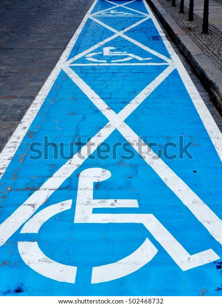 Three parking spaces for disabled people - painted\
on the street