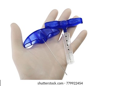 Three Parts Of Bone Marrow Biopsy Needle Held In Palm Of Doctor Left Hand In Powdered Latex Glove, White Background