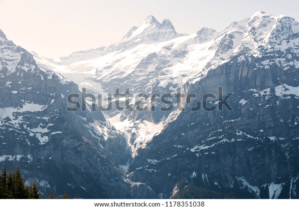 Three peaks of mountain Alps looking from grindelwald\
first peak electric cable car , Switzerland Europe  ( Eiger ,\
MÃ¶nch and Jungfrau  )