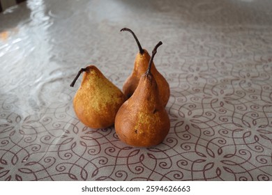 Three pears standing on a table