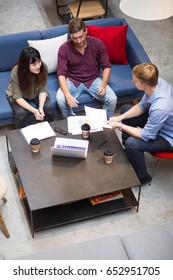 Three People Discussing Business Issues In Cafe