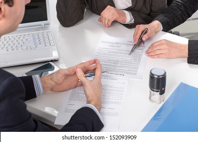 Three People Sitting At A Table Signing Documents, Hands Close-up