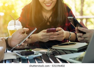 Three People Using Smartphone In Coffee Shop, Internet Of Things Conceptual