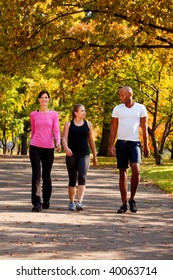 Three People Walking In A Park, Getting Some Exercise