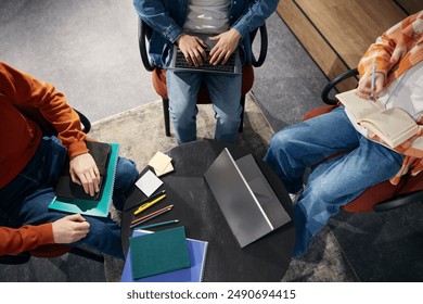 Three people working using laptops in office above view