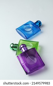 Three Perfume Bottles With Elegant Blue, Purple And Green Colors,selective Focus,soft Focus And Shinny Texture