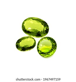 Three peridot or chrysolite gems on a white background