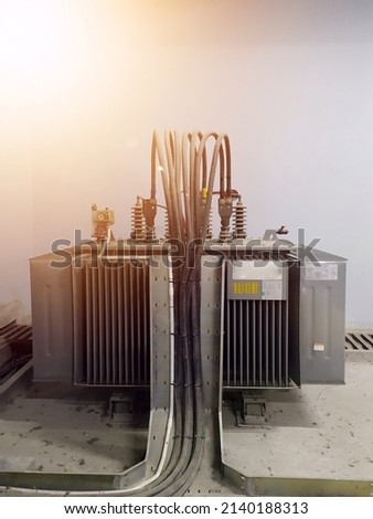 Three phase electrict transformer 1000 Kva isolated on white,with shiny lights.