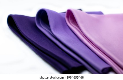 Three pieces of lycra fabrics folded in white background.