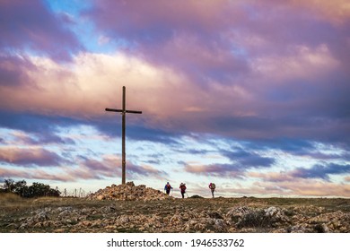 Three Pilgrims at the Cruz de Maragrande Summit outside Atapuerca along the Way of St James Pilgrimage Trail Camino de Santiago