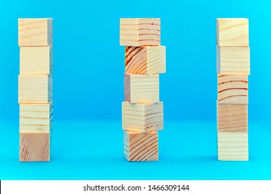 Three Pillars Of Wooden Cubes, Place Your Advertising Slogan On A Blue Background.