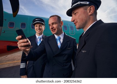 Three Pilots Taking A Picture Of Themselves On Smartphone