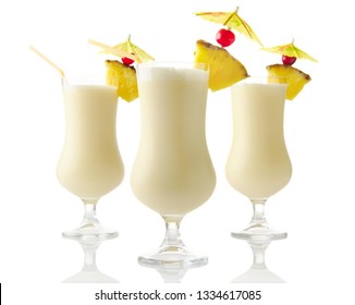 Three Pina colada coconut cocktails isolated on white background