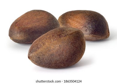 Three pine nuts on a white background. Full depth of field. With clipping path
