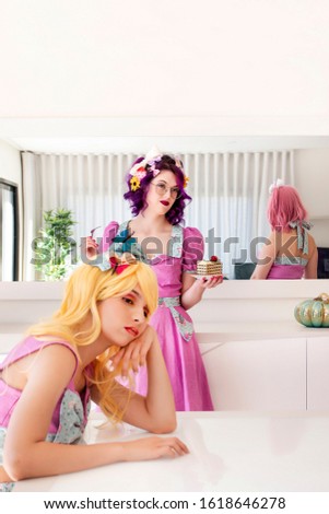 Three pinup girls with purple dresses on the table with mirror.