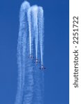 Three planes performing a synchronized flying display during an aerobatic show	