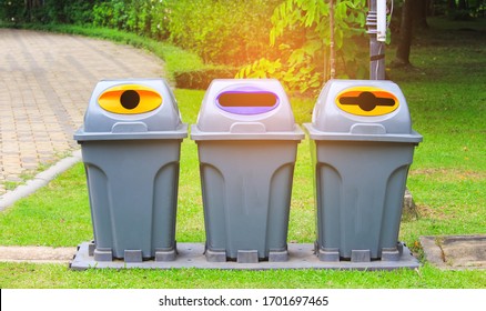 Three Plastic  Waste Bins Are Located On The Grass In The Park. Concept Environmental Stewardship