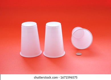 Three Plastic White Disposable Glasses Thimble Game One Glass Is Knocked Over Under Him Win. Togt Demonstration That In The Game You Can Win