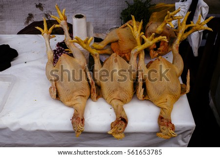 three plucked chicken on a market in peru Urubamba/ peru / south america
