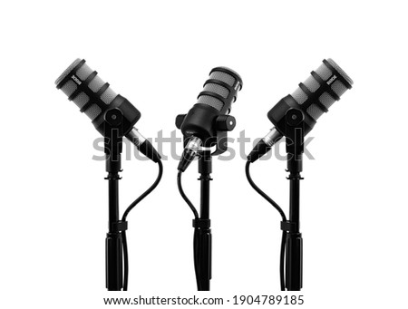 Three podcast microphones on a tripod, a black metal dynamic microphone on an isolated white background, for recording podcast or radio program, show, sound and audio equipment, technology, Photo, DJ