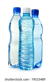 Three polycarbonate plastic bottles of mineral water isolated on white