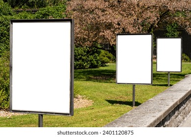 Three portrait format blank billboards at a park. - Powered by Shutterstock