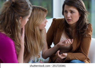 Three pretty friends having a serious conversation - Powered by Shutterstock