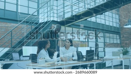 Three professionals reviewing documents and pointing at screen in open-plan office, with coffee cup. Collaboration, teamwork, moderndesign, workspace, businessprofessional, corporateoffices