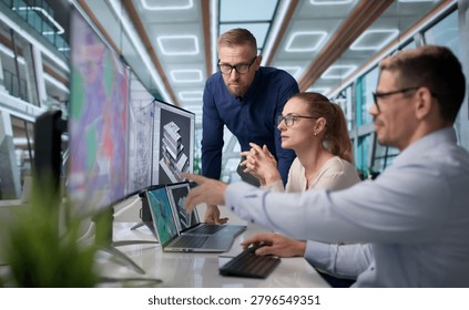 Three Professionals Use BIM Software On Laptops For Urban City Planning.
